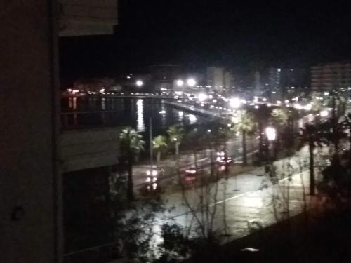 a view of a city at night with lights at CHEAP AND COMFORTABLE APARTMENT AT SEASIDE in Vlorë