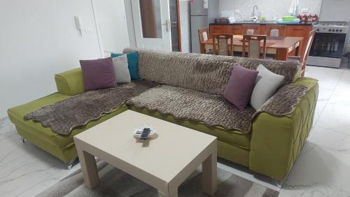 a living room with a couch and a table at XXL APARTMENTS CiTY CENTAR in Bitola