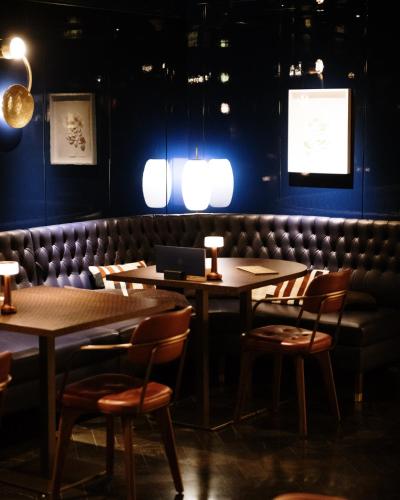 a dining room with two tables and a bench at Gallery Hotel 4 Sup in Barcelona