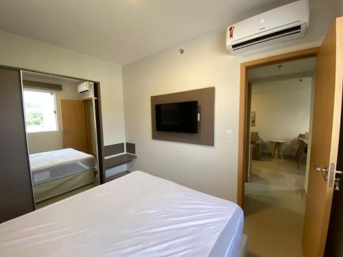 a hospital room with a bed and a television at Flat Park Veredas com Vista Serra com geladeira e fogão in Rio Quente