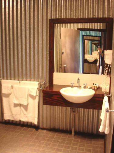 a bathroom with a sink and a mirror at Black Sheep Inn in Orange