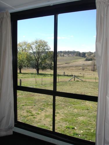 a view of a field from a window at Black Sheep Inn in Orange