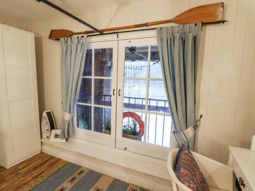 a window in a room with a view of a yard at Horton Lodge Boathouse in Leek