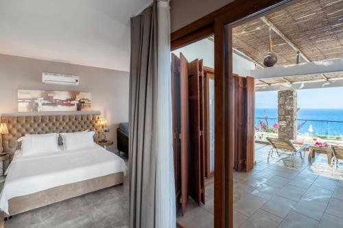 a bedroom with a bed and a view of the ocean at Vega Aparts in Gümüşlük