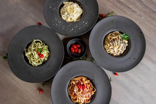 a group of plates of food on a table at Novotel Criciuma in Criciúma