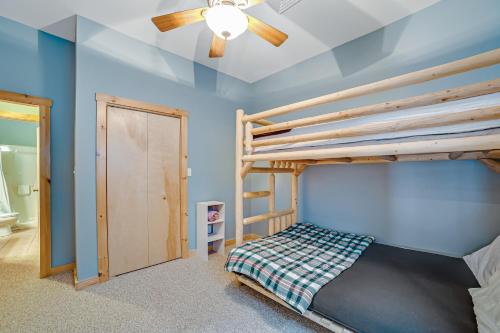 a bedroom with a bunk bed and a ceiling fan at Contemporary ADK 5 Bedroom Chalet on Schroon in Schroon Lake