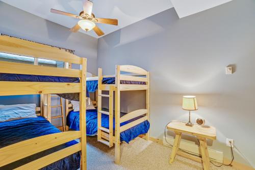 a bedroom with two bunk beds and a ceiling fan at Contemporary ADK 5 Bedroom Chalet on Schroon in Schroon Lake