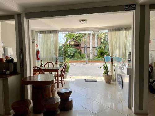 a kitchen and dining room with a table and chairs at Pousada Veleiro in Fortaleza