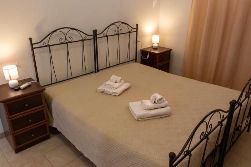 a bedroom with a bed with two towels on it at La Masseria Hotel Ristorante Centro Benessere in Cocumola