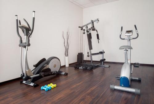 a room with three exercise bikes and a gym at Express Kraków Hotel in Kraków