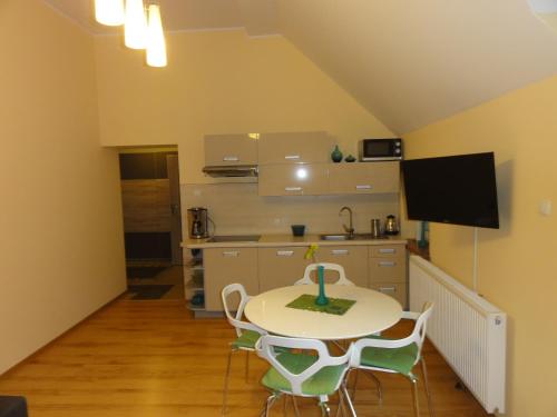 a kitchen with a table and chairs in a room at Apartament Bukowa in Wisła