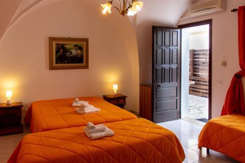 En eller flere senger på et rom på La Masseria Hotel Ristorante Centro Benessere