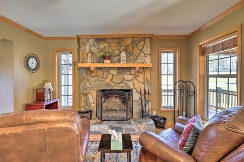 a living room with a stone fireplace at half Mi to River Spacious Blue Ridge Gem with Views! in Piney Creek