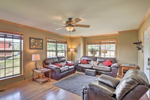 a living room with leather furniture and a ceiling fan at half Mi to River Spacious Blue Ridge Gem with Views! in Piney Creek