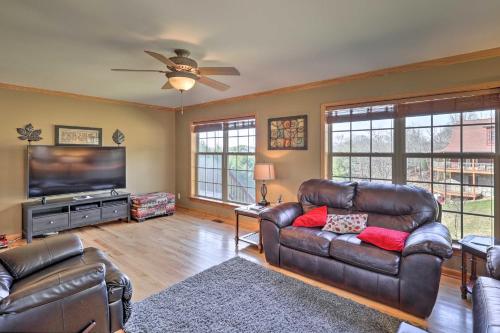 a living room with leather furniture and a flat screen tv at half Mi to River Spacious Blue Ridge Gem with Views! in Piney Creek