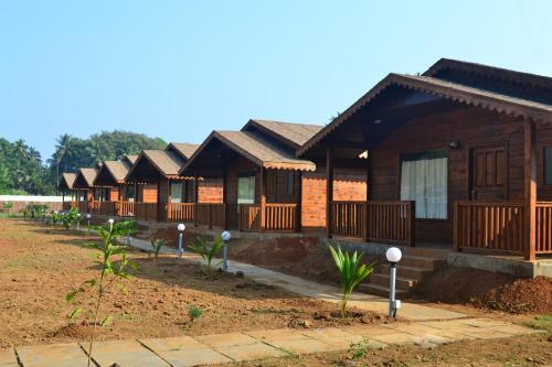 a row of wooden houses in a row at Radhika Eco Resort(Odonata) in Arambol
