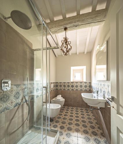 a bathroom with a shower and a sink and a toilet at Podere GIUSTI in Reggello