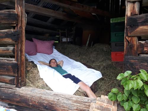 a person laying on a bed in a cabin at Schmiedhof in Seefeld in Tirol