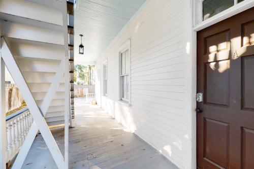 a hallway of a house with a door and stairs at 243 Rutledge in Charleston