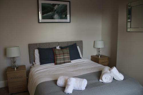 a bedroom with a bed with towels on it at Carvetii - Quentin House - Near Hospital, max 7 ppl in Carlisle