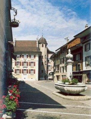 a street in a town with buildings and a clock tower at Hotel Krone in Wangen an der Aare