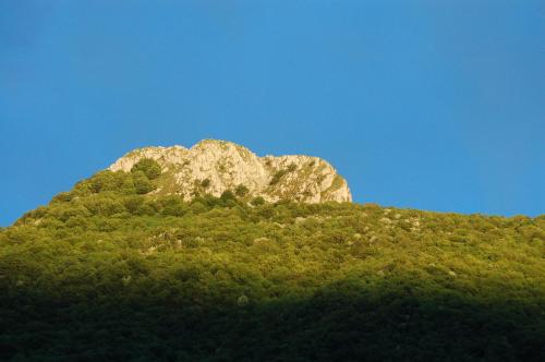 a large rock on top of a green hill at Albergo Sala in Valbrona
