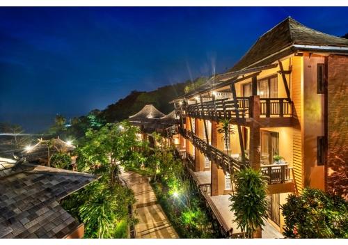 a view of a building at night at Nirvana Beach Resort, Koh Lanta SHA Extra Plus in Ko Lanta