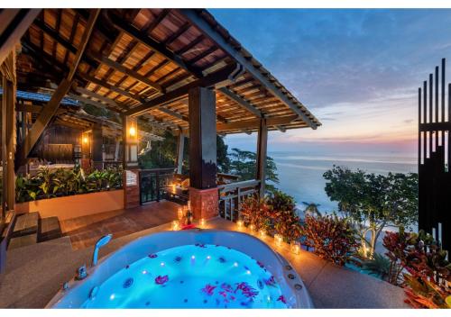 a house with a hot tub on a patio at Nirvana Beach Resort, Koh Lanta SHA Extra Plus in Ko Lanta