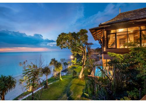 a house with a view of the water at Nirvana Beach Resort, Koh Lanta SHA Extra Plus in Ko Lanta