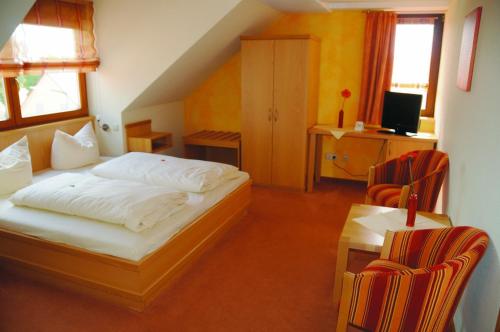 1 dormitorio con 1 cama, mesa y sillas en Hotel Schwarzes Ross, en Schwarzach am Main