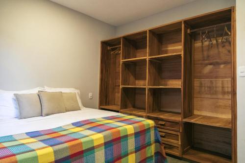 a bedroom with a bed and a large closet at La Casina Jericoacoara in Jericoacoara