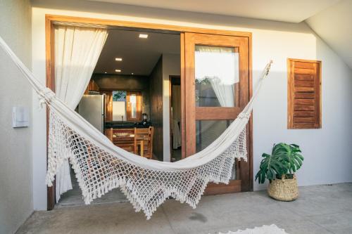 a hammock hanging in aoyer of a house at La Casina Jericoacoara in Jericoacoara
