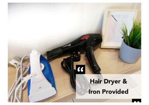 a hair dryer and an iron on a counter at Subang City Residence, 8-9 pax with Balcony, Walking Distance to Summit, 5min to Sunway in Subang Jaya