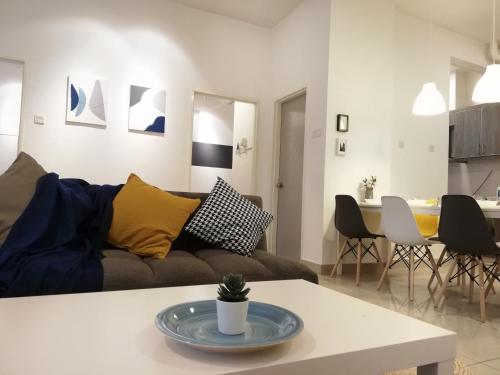a living room with a couch and a table at Subang City Residence, 8-9 pax with Balcony, Walking Distance to Summit, 5min to Sunway in Subang Jaya