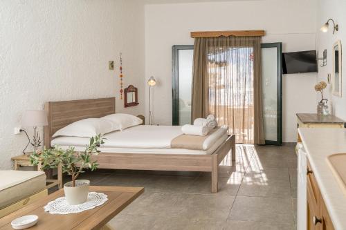 a bedroom with a bed and a table in a room at Villa Plori in Makry Gialos