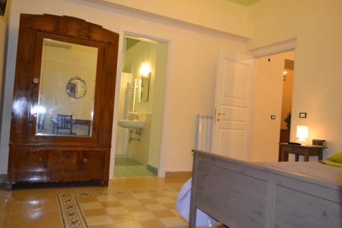 a bedroom with a bed and a door and a bathroom at B&B Palazzo Corvino in Palermo