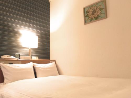 Ein Bett oder Betten in einem Zimmer der Unterkunft Smile Hotel Towada
