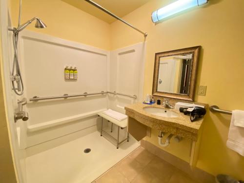 a bathroom with a sink and a shower and a mirror at Holiday Inn Express & Suites Perry, an IHG Hotel in Perry