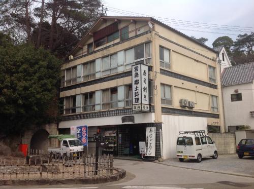 a white van parked in front of a building at Yamaichi Bekkan in Miyajima