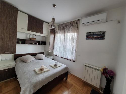 a bedroom with a bed with two towels on it at Apartment Iris in Belgrade