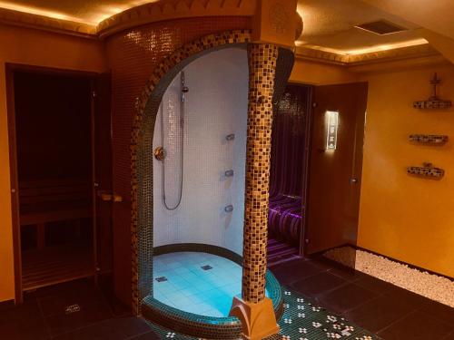 a large bathroom with a shower with a mirror at Apartmány PRESTIGE Donovaly in Donovaly