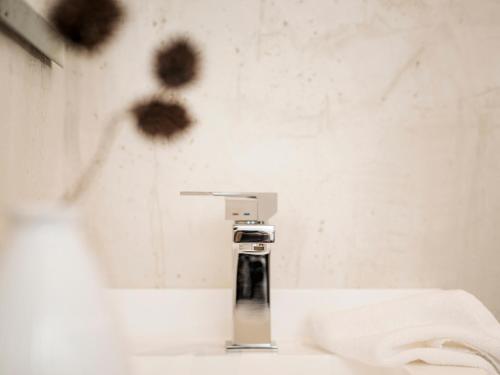 a bathroom with a faucet on a sink at LENZup Apartments in Mayrhofen