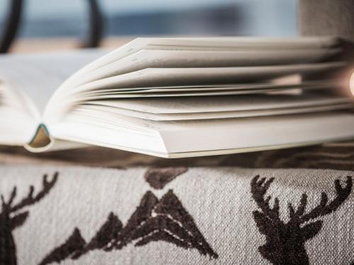 a stack of books sitting on top of a table at LENZup Apartments in Mayrhofen