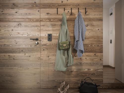 a wooden door with clothes hanging on it at LENZup Apartments in Mayrhofen