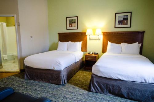 a hotel room with two beds and a room at Candlewood Suites Temple by IHG in Temple