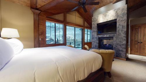 a bedroom with a large bed and a fireplace at The Landmark in Vail