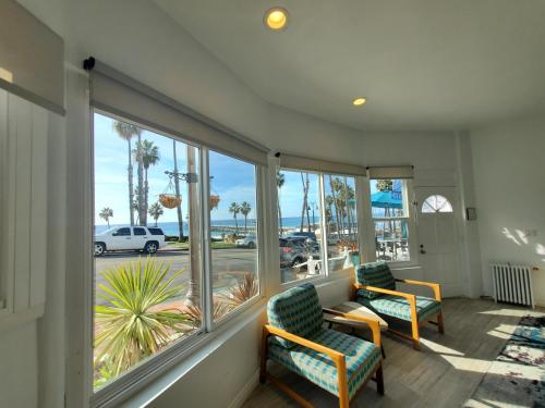 a waiting room with two chairs and a large window at Sea Horse Resort in San Clemente