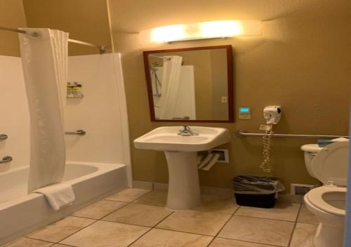 a bathroom with a sink and a toilet and a mirror at Candlewood Suites Temple by IHG in Temple