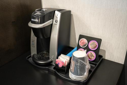 a coffee maker sitting on top of a table at Red Carpet Inn in Banff