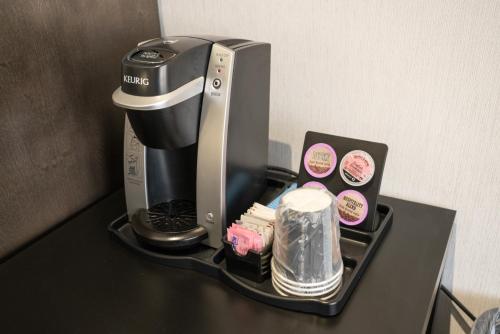 a coffee maker sitting on top of a table at Red Carpet Inn in Banff